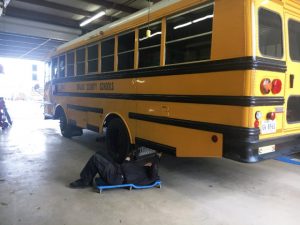 THP Trooper/Inspector Ned Martin checking under bus at school bus garage