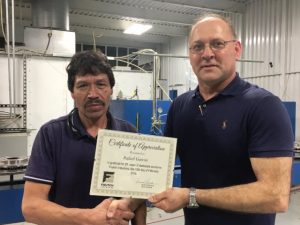 Tracy Foutch of Foutch Industries presented a certificate to Rafael Garcia for 20 years of service, the longest serving employee, during an employee appreciation lunch Thursday