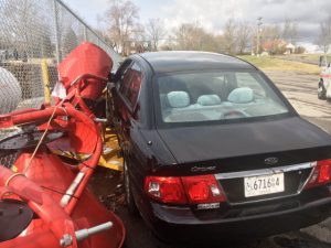 2006 Kia Optima Comes to Rest on Farm Equipment (Bush Hog Mowers) at Tractor Supply after crash