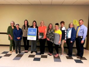 Pictured from left to right: Lisa Cripps, Helen Sefsik, Megan Kinslow, Colleen Wright, Elise Driver, Mandy Lawson, Norene Puckett, Shan Burklow, Kristi Paling, and Sheriff Patrick Ray.