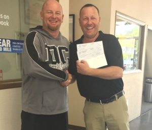 Jimmy White of Florence and White Ford presents check to Tigerette Softball Coach Danny Fish