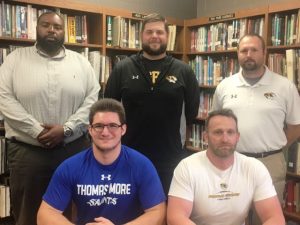 Nick May seated with Tiger Coach Steve Trapp. STANDING: Assistant Coaches Justin Burum, Thomas Cagle, and Tommy Hinch