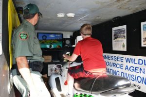 TWRA Officer Joe Fortner shows student how BUI simulator operates