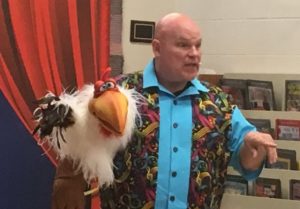 Barry Mitchell and Hyena the Chicken entertain children at Justin Potter Library