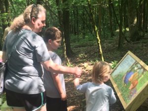 Tina Stout, Eli, and Blakely take a walk on the Story Book Trail at Edgar Evins State Park in June 2018