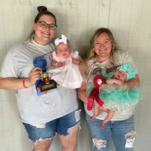 DeKalb Fair Baby Show: Girls one-day – three-month: From left, winner Emerson Grace Orchard, three-month old daughter of Donny and Elisha Orchard of Smithville; runner up, Raelynn Goodwin, one month-old daughter of Kyra and Dakota Goodwin of Alexandria.