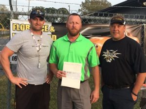 Coach Steve Trapp, Jimmy White of Florence & White Ford, and former DCHS Quarterback Club President Darrell Gill