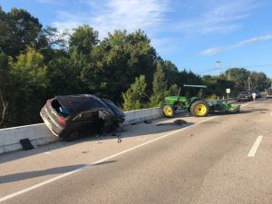 Two people escaped injury in a crash involving an SUV and a farm tractor pulling a bush hog today (Wednesday) on Highway 70 at Liberty.