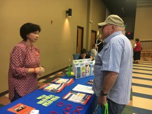 Carl Lee Webb speaks with Suzanne Angel at Health Fair Friday