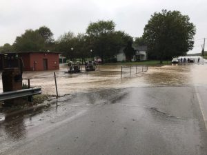 Creek waters spilled over their banks and blocked East Main Street in Alexandria Monday