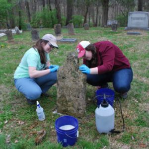 Here, MTSU Public History graduate students Elizabeth Foster Morris (left) and Typhanie Schafer scrub tombstones in the historic Cane Ridge Presbyterian Church graveyard in March 2018.