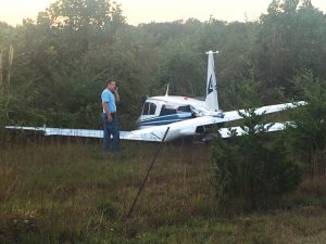 Lee Bridges, certified Airframe and Powerplant Mechanic , surveys scene of Wednesday evening plane crash