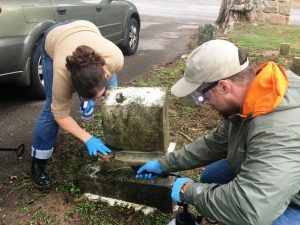 Dr. Stacey Graham (left) Research Professor for the MTSU Center for Historic Preservation, demonstrates proper technique for cleaning tombstone at Smithville Town Cemetery