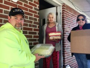 Dustin and Kristie Johnson of the DeKalb County Emergency Services Association delivering Thanksgiving Day meals last year