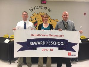 Director of Schools Patrick Cripps joined Principal Sabrina Farler and Assistant Principal Joey Agee in displaying a new banner proudly proclaiming DeKalb West School as a Reward School for 2017-18. The designation was recently announced by the Tennessee Department of Education for the school’s academic excellence