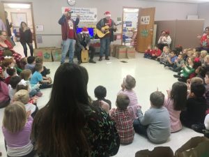 The Collins Family leads the children in singing “Jingle Bells” at Smithville Head Start Center