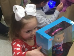 Head Start student excited to see what Santa brought her