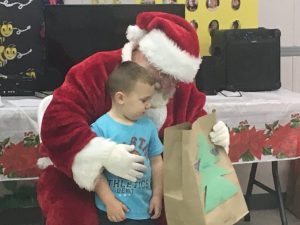 Santa delivers bags of gifts to children at Smithville Head Start Center