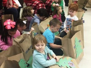 Excited Head Start students anxious to see what Santa brought them