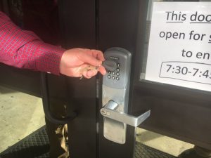 DCHS Principal Randy Jennings demonstrates use of key fob at high school