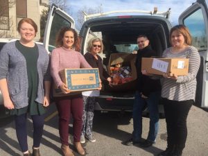 Director of Schools Patrick Cripps with Central Office Staff Amy Lattimore, Elise Driver, Melissa Pirtle, and Martha Taylor loading van with food boxes to be delivered to families served by the Coordinated School Health’s Backpack Program