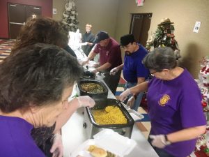 Volunteers filling food trays