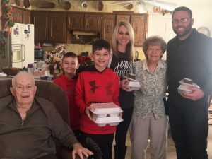 Smithville Mayor Josh Miller and his family deliver Christmas Eve Meals on behalf of the DESA to Gene and Dean Cook on Cill Street. Pictured: Gene Cook, Ethan, Kaden, Melissa, Dean Cook, and Josh