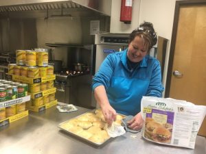 Kristie Johnson preparing rolls for food trays