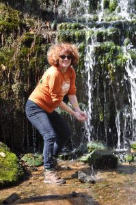 Lori Christensen, owner of Cannon Arts Studio, Smithville and Woodbury, takes a close and personal look at a waterfall on tour