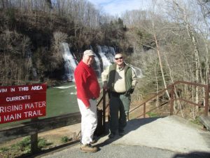 Waterfall Tour by Friends of Edgar Evins State Park Coming March 23. Fount Bertram, Past President of Friends of Edgar Evins State Park and Edgar Evins Park Ranger Justin Vaughn pose before the Twin Falls at Rock Island State Park on their pre-run for the event.