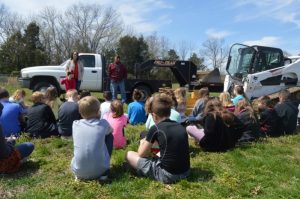 Students watch as Luke Prichard with Luke Prichard Excavating & Trucking talks about his work.