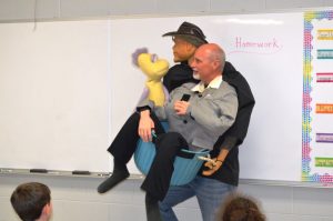 Ventriloquist David Turner discusses his job as an entertainer with the students at DeKalb West School during Career Day