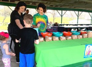 Martha Taylor and Elise Driver of the Coordinated School Health Program offering treats from the trail mix bar to kids during Saturday’s “A Day at the Park” hosted by the DeKalb Prevention Coalition and the Community Advisory Board