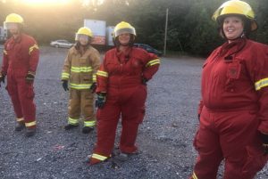 DeKalb Citizens Fire Academy participants Jacob Parsley, Beth Pafford, Rhonda Caplinger and Dana Scott wait their turn to use the jaws of life to remove car doors and a car top.