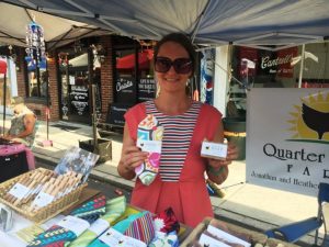 Heather Bradley of Quarter Spring Farm displays Goat Milk Soap and reusable napkins at Summer Kick-Off Block Party downtown Smithville Saturday