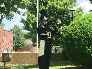 Josh Moon blows taps to bring Memorial Day Program to a close