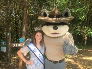 Miss Teen Tennessee Beauty Supreme, Gracie Travis of Woodbury joined Ranger Ramble, the Tennessee State Park mascot, in cutting the ribbon Saturday for the updated Story Book Trail at Edgar Evins State Park.