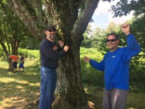 Chris Key and Casey Midgett putting up clothes line at residence on Highway 56 south