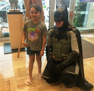 Batman makes an appearance at Justin Potter Library Thursday to the delight of the chilldren