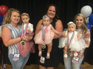 Miss Jamboree Pageant (Ages 7 to 12 months), the winner is Peyton Rae Shepherd (center). Runners-up pictured left to right: 2nd- Reese Everly Leiser, Queen Peyton Rae Shepherd, and 1st-Briar Rose Kilgore