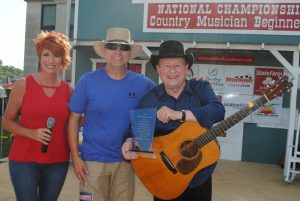 Sam Stout, President & Coordinator of The Smithville Fiddlers’ Jamboree and Shan Williams, Director of Marketing for the festival presented the 2019 Blue Blaze Award to Bluegrass legend Ronnie Reno Saturday prior to a performance by Reno and his band on the Jamboree stage