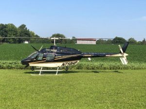 THP officers land helicopter near bean field off Midway Road in DeKalb County after conducting aerial search for Michael Holden Thomas