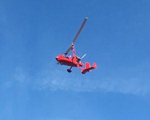 Wayne Hubbs flies high above Smithville Municipal Airport in his Gyrocopter Saturday during Young Eagles Flight Rally