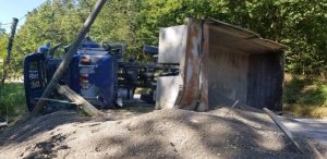 A truck driver was airlifted Thursday after his dump truck overturned spilling its load of gravel on Dale Ridge Road (Highway 96). (Jim Beshearse Photo)