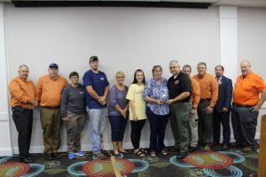 THP Captain R.C. Christian (pictured 5th from right) presents the Upper Cumberland EMS Directors Association’s Lifetime Achievement Award to Cheryl Cole, the widow of award honoree Jeff Cole. Other members of the Cole family also pictured along with DeKalb EMS Director Hoyte Hale (far left), Preston Denney-Warren County EMS Director (next to Hale), Mike Kerr-White County EMS Director (next to Christian), Brian Tompkins- Region IV State Consultant for the 14 County Upper Cumberland Region (next to Kerr), Brandon Ward-State EMS Director (next to Tompkins), and Tim Booher-Director of Air Evac Life Flight and President of the Upper Cumberland EMS Director Association (far right)