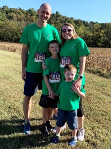 Beckett West, age 5, was the Face of the Race for the 5th Annual 3.21Run4DS race last Saturday in Liberty. Pictured with his parents Andy and Courtney West and his 9 year old brother Keaton