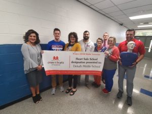 The DeKalb County School District has been designated a Project ADAM Heart Safe School District. DeKalb Middle School staff being presented with their Heart Safe School designation banner