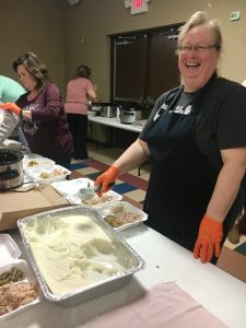 Wanda Redman along the volunteers preparing food trays for the needy on Thanksgiving