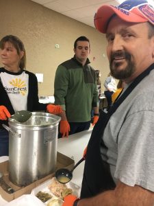 Grady Prichard and others preparing food trays for the needy on Thanksgiving Day