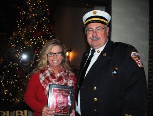 Smithville Deputy Fire Chief Hoyte Hale presents plaque to Tara Hale of DeKalb Funeral Chapel for winning 1st place Float in the Smithville Christmas Parade Saturday evening